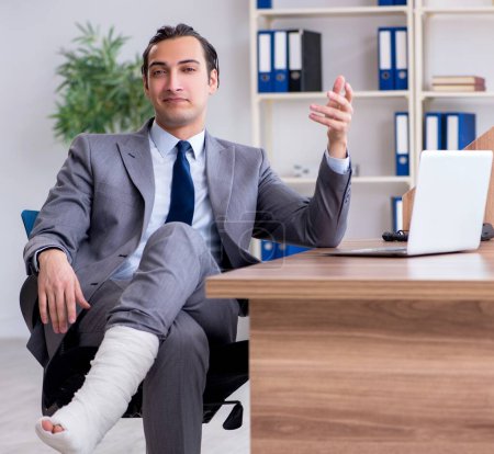 Foto de La pierna lesionado empleado masculino en la oficina - Imagen libre de derechos