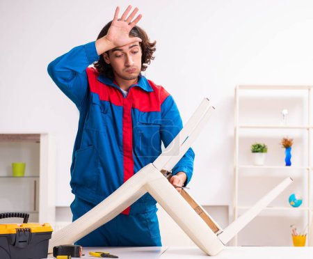 Photo for Young carpenter working assembling furniture - Royalty Free Image