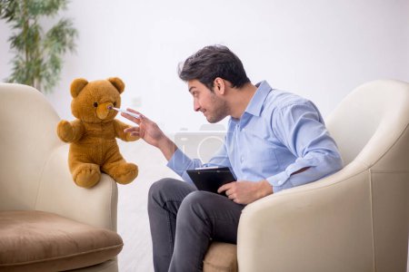 Photo for Young psychologist meeting with toy bear - Royalty Free Image