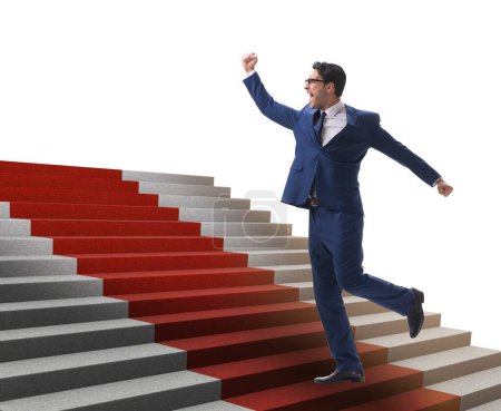Foto de Joven hombre de negocios subiendo escaleras y alfombra roja sobre fondo blanco - Imagen libre de derechos