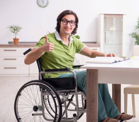 Photo for The young male student in wheelchair at home - Royalty Free Image