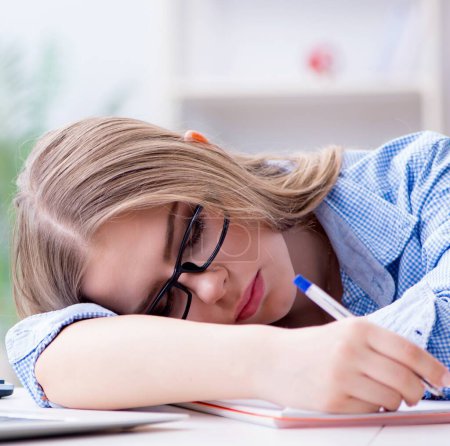 Photo for The young teenage female student preparing for exams at home - Royalty Free Image
