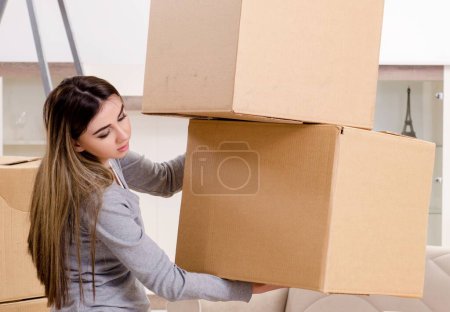 Photo for The young beautiful woman moving to new flat - Royalty Free Image