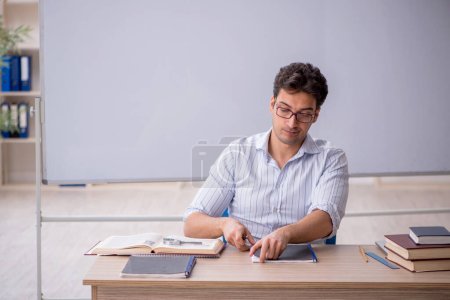 Photo for Young teacher in front of white board - Royalty Free Image