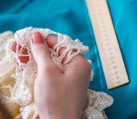 Photo for Woman tailor working on a clothing sewing stitching measuring fabric - Royalty Free Image