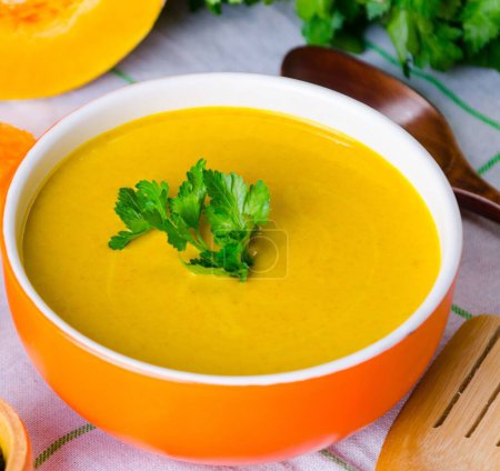 Photo for The pumpkin soup served on the table in bowl - Royalty Free Image