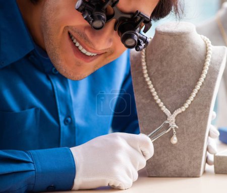 Photo for The young jeweler working in his workshop - Royalty Free Image