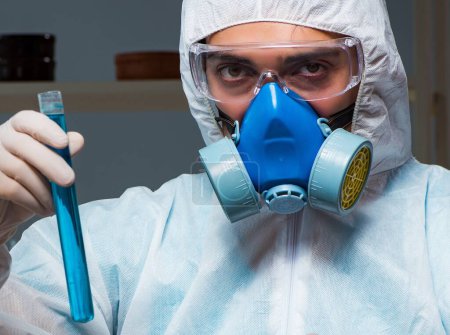 Photo for The forensic investigator working in lab looking for evidence - Royalty Free Image