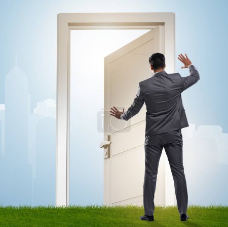 Photo for The businessman standing in front of door into future - Royalty Free Image