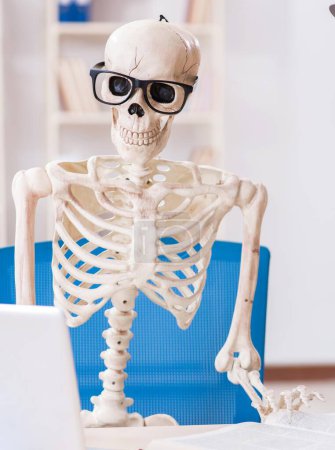 Photo for The skeleton businessman working in the office - Royalty Free Image