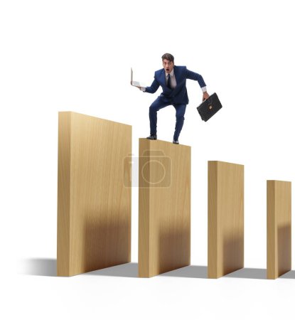 Businessman in the domino effect concept
