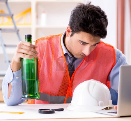 Photo for The drunk engineer working in the workshop - Royalty Free Image