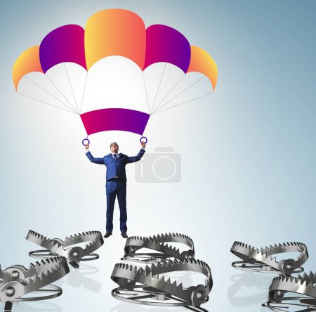 Photo for Businessman falling into trap on parachute - Royalty Free Image