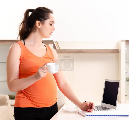 Photo for The young pregnant woman working at home - Royalty Free Image