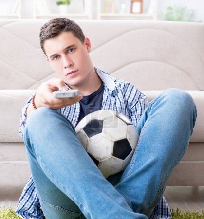 Photo for The young man student watching football at home - Royalty Free Image