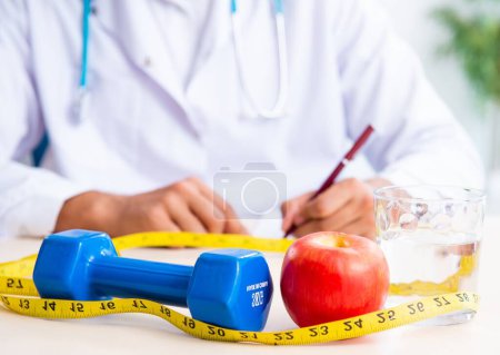 Photo for The young male doctor in sport and dieting concept - Royalty Free Image