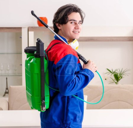 Photo for The young contractor doing pest control at home - Royalty Free Image