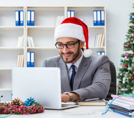 Photo for The young businessman celebrating christmas in the office - Royalty Free Image