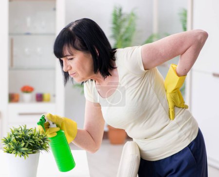 Photo for The old mature woman tired after house chores - Royalty Free Image