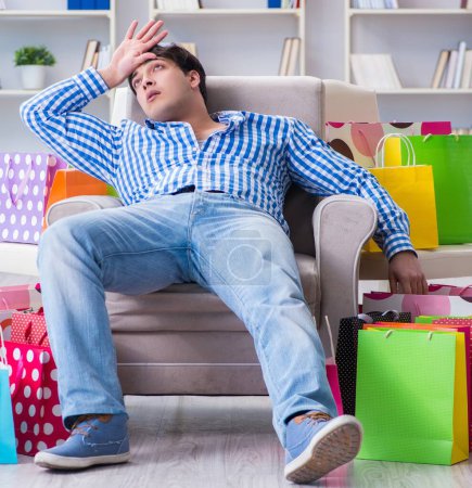 Photo for The young man after excessive shopping at home - Royalty Free Image