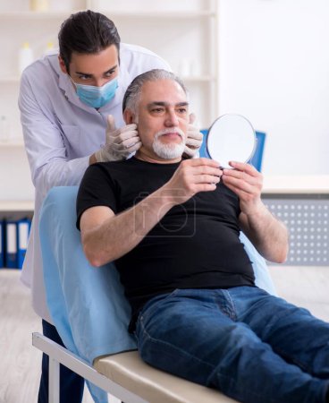 Photo for The old man visiting young doctor for plastic surgery - Royalty Free Image