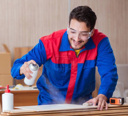 Photo for The yooung repairman carpenter working with paint painting - Royalty Free Image