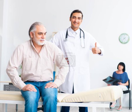 Photo for The old couple visiting young male doctor - Royalty Free Image