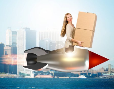 Photo for The woman in fast box delivery service on rocket - Royalty Free Image
