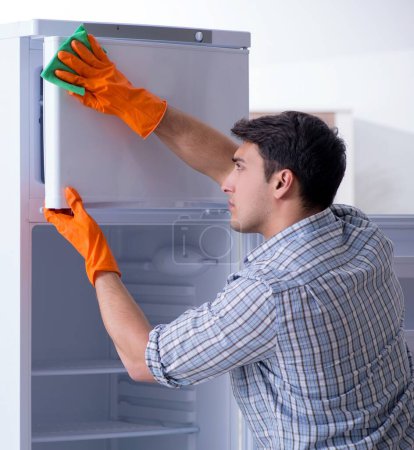 Photo for The man cleaning fridge in hygiene concept - Royalty Free Image