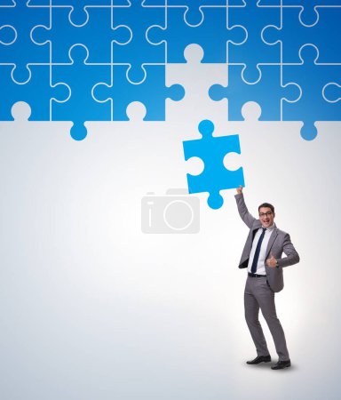 Photo for The concept of businessman with missing jigsaw puzzle piece - Royalty Free Image