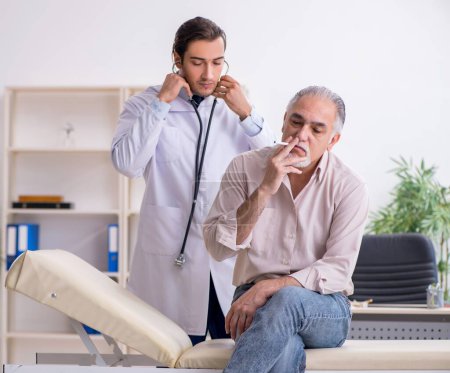 Photo for Young doctor and old patient in antismoking concept - Royalty Free Image