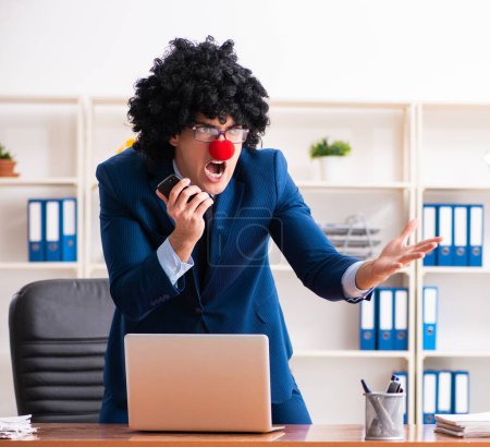 Photo for The young clown businessman working in the office - Royalty Free Image