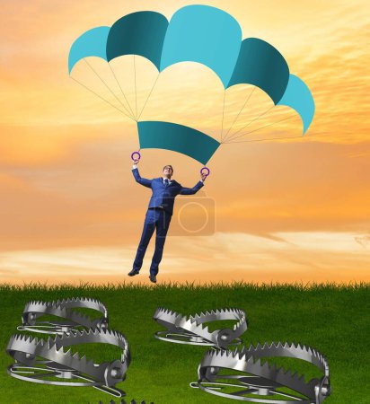 Photo for The businessman falling into trap on parachute - Royalty Free Image