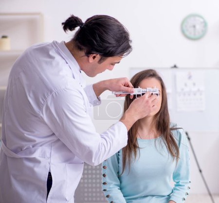 Photo for The young woman visiting male doctor oculist - Royalty Free Image