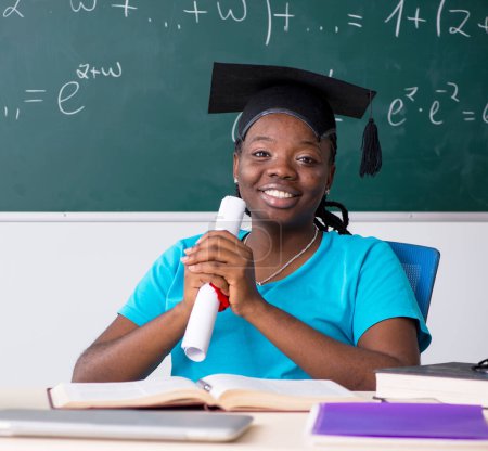 Photo for The black female student in front of chalkboard - Royalty Free Image