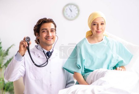 Photo for The young handsome doctor visiting female oncology patient - Royalty Free Image
