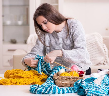 Photo for The young beautiful woman knitting at home - Royalty Free Image