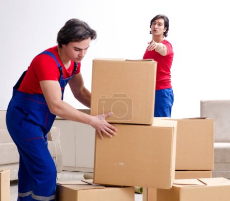 Photo for The two young contractor employees moving personal belongings - Royalty Free Image