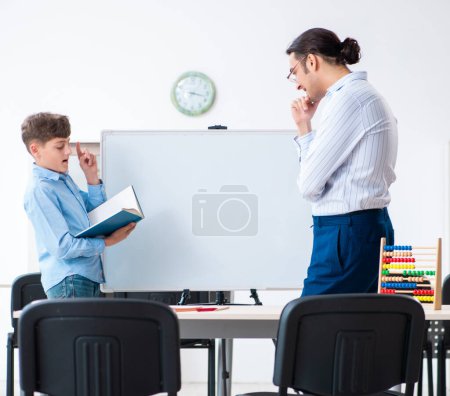 Photo for The young father helping his son to prepare for exam - Royalty Free Image