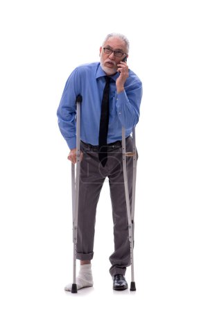 Téléchargez les photos : Vieux patron mâle avec des béquilles isolées sur blanc - en image libre de droit