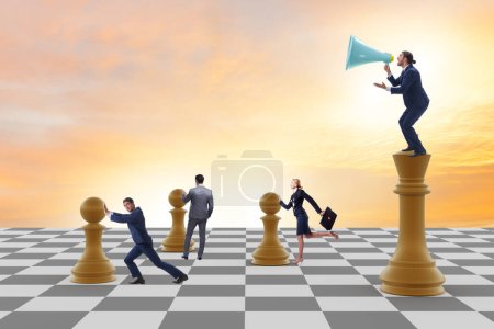 Businessman shouting in game of chess puzzle 700344598