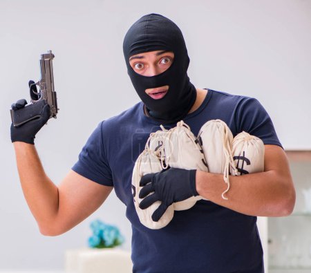 Photo for The robber wearing balaclava stealing valuable things - Royalty Free Image