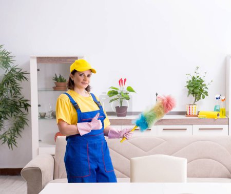 Photo for The old female contractor doing housework - Royalty Free Image