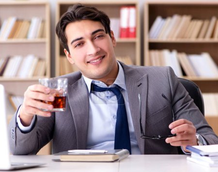 Photo for The young businessman drinking from stress - Royalty Free Image