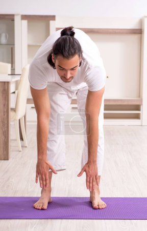 Photo for The young man doing physical exercises at home - Royalty Free Image
