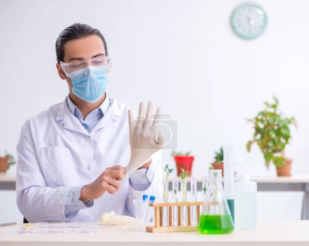 Photo for The young male chemist working in the lab - Royalty Free Image