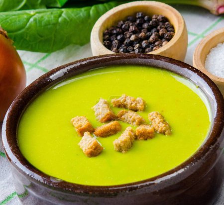 Photo for Spinach soup served on wooden board - Royalty Free Image