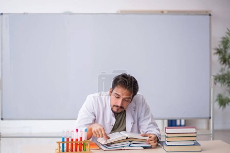 Photo for Young chemist teacher in front of whiteboard - Royalty Free Image