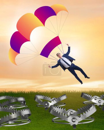 Foto de El empresario cayendo en la trampa en paracaídas - Imagen libre de derechos