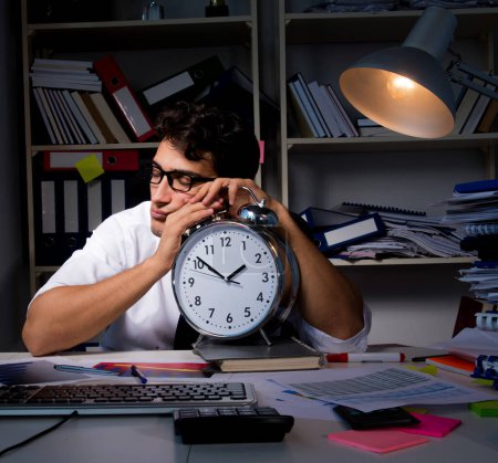 Photo for The man businessman working late hours in the office - Royalty Free Image